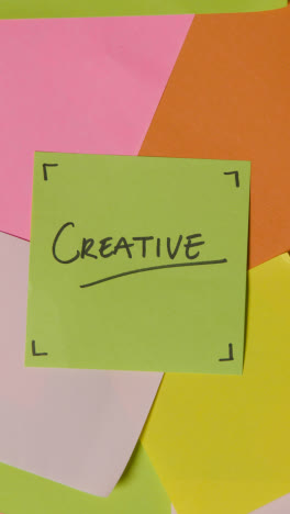 Vertical-Video-Business-Concept-Of-Revolving-Sticky-Notes-With-Creative-Written-On-Top-Note-1